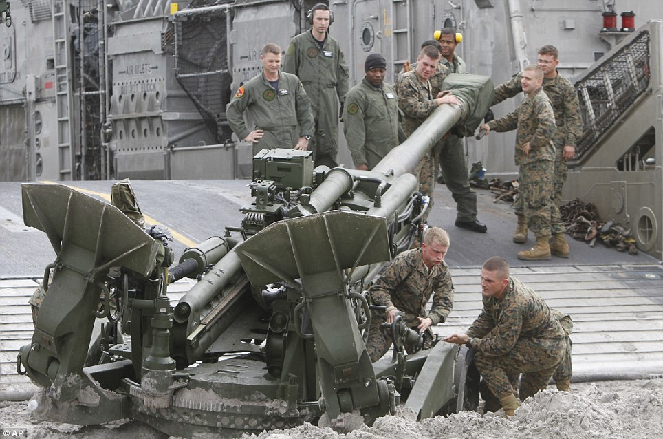 Storm: Marines help to move an artillery piece after landing on a beach near Camp Lejeune, North Carolina, during the Bold Alligator exercise